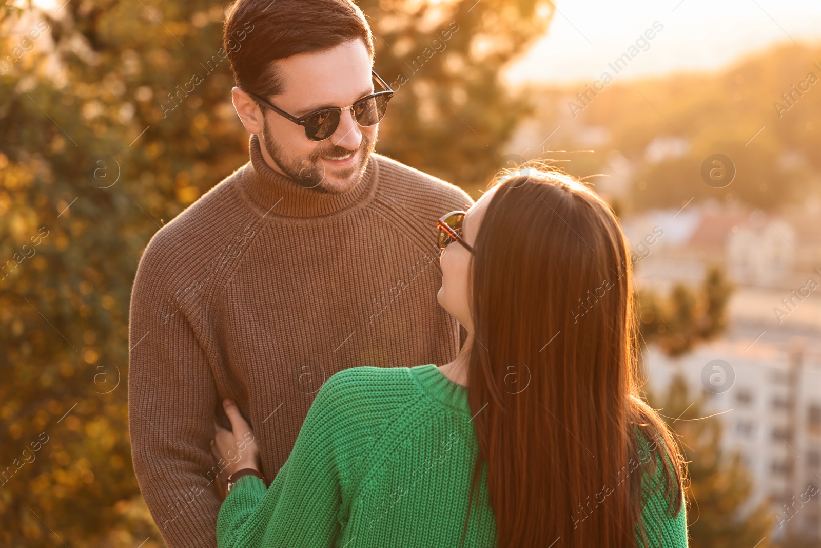 Photo of Cute couple enjoying their time together outdoors in autumn evening