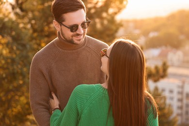 Cute couple enjoying their time together outdoors in autumn evening