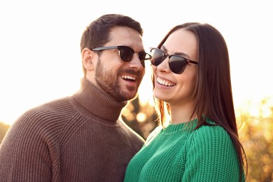 Beautiful couple enjoying their time together outdoors in autumn evening