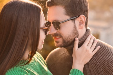 Beautiful couple enjoying their time together outdoors in autumn evening