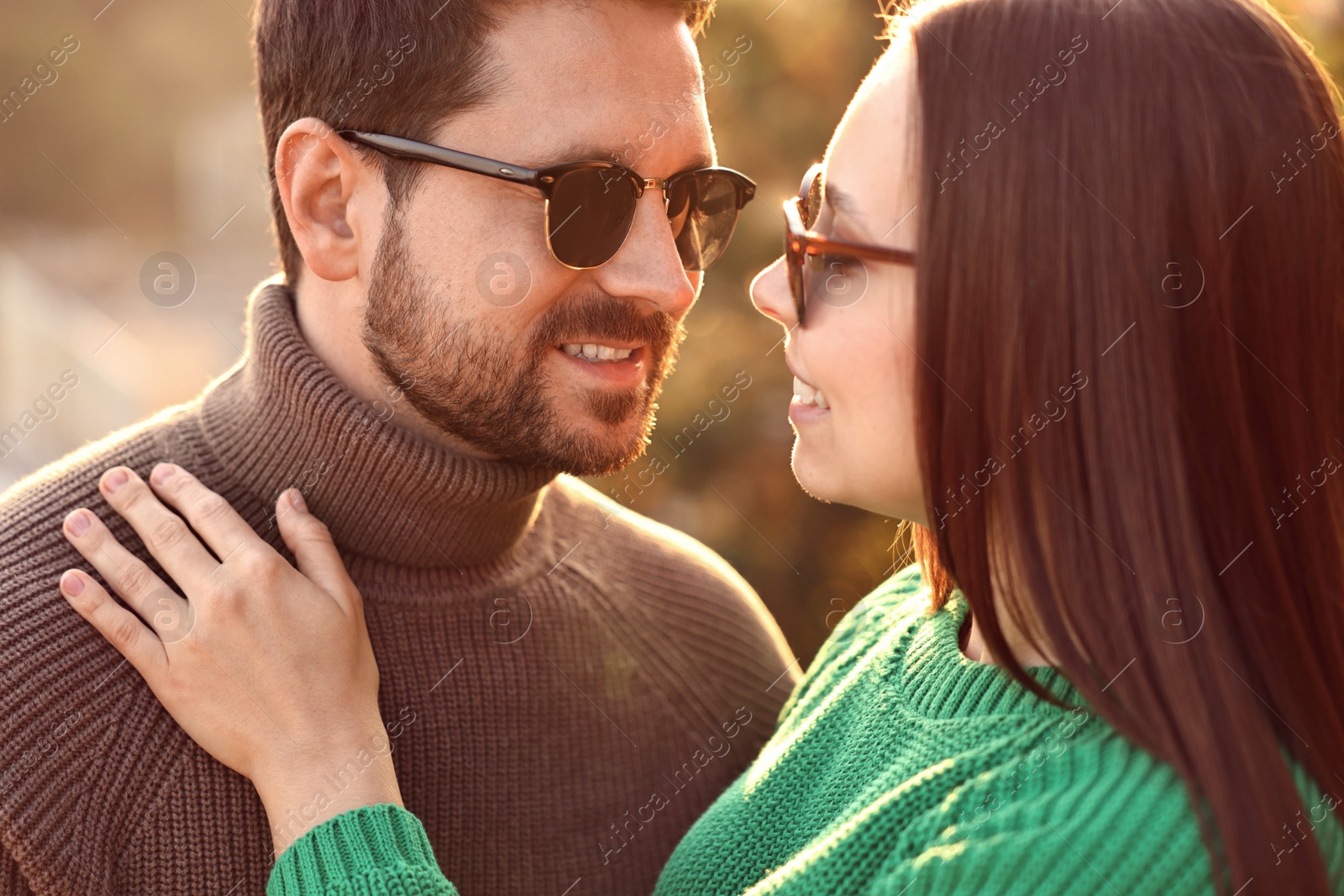 Photo of Beautiful couple enjoying their time together outdoors in autumn evening