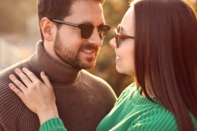 Beautiful couple enjoying their time together outdoors in autumn evening