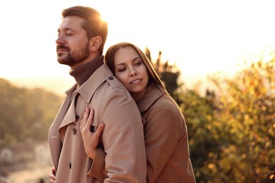 Beautiful couple enjoying their time together outdoors in autumn evening