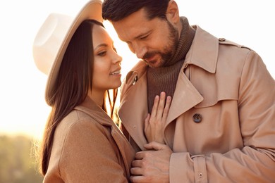 Beautiful couple enjoying their time together outdoors in autumn evening