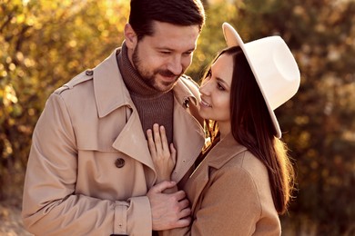 Photo of Beautiful couple spending time together in autumn park