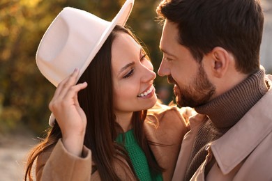 Beautiful couple spending time together in autumn park