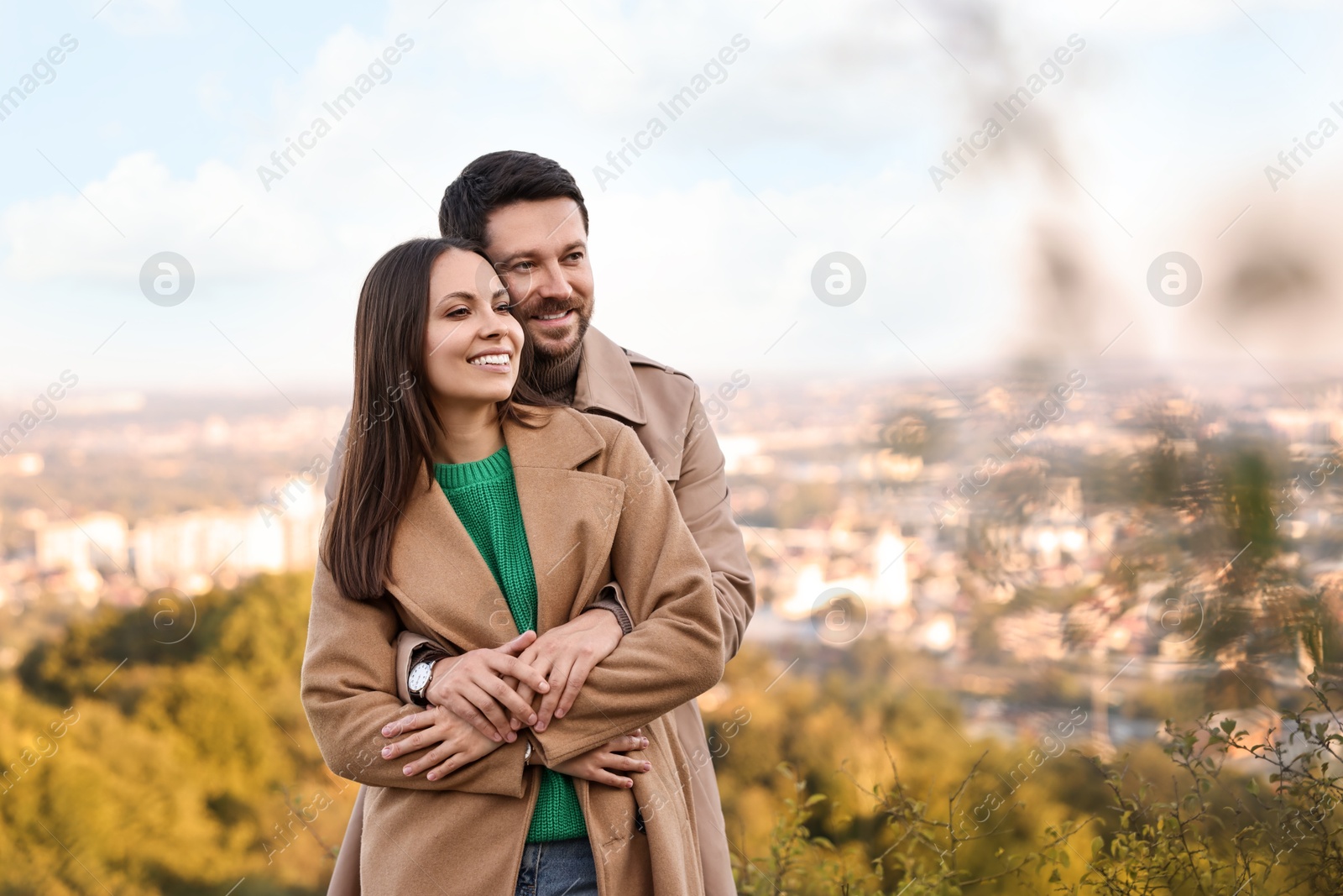 Photo of Beautiful couple hugging outdoors on autumn day, space for text