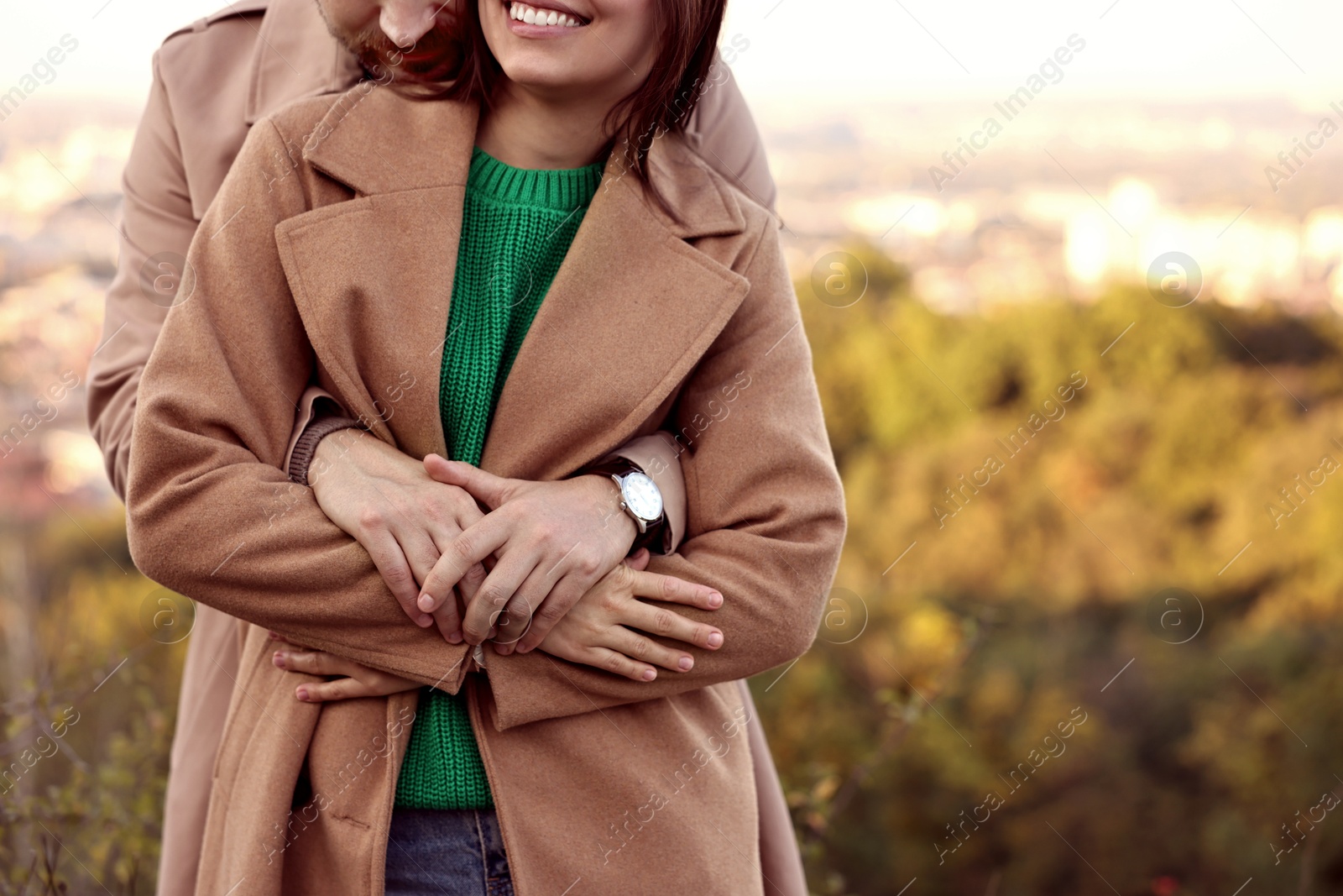 Photo of Couple hugging outdoors on autumn day, closeup. Space for text