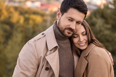 Photo of Beautiful couple hugging in park on autumn day