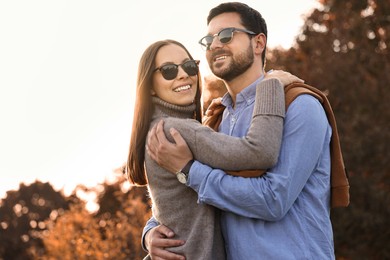 Photo of Beautiful couple spending time together in autumn park