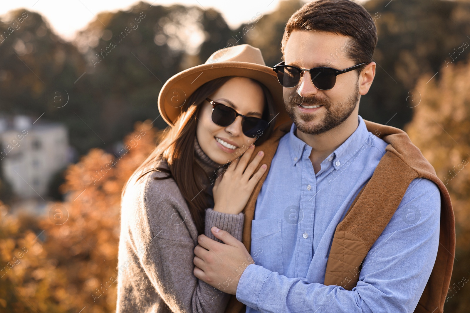 Photo of Beautiful happy couple in sunglasses outdoors on autumn day