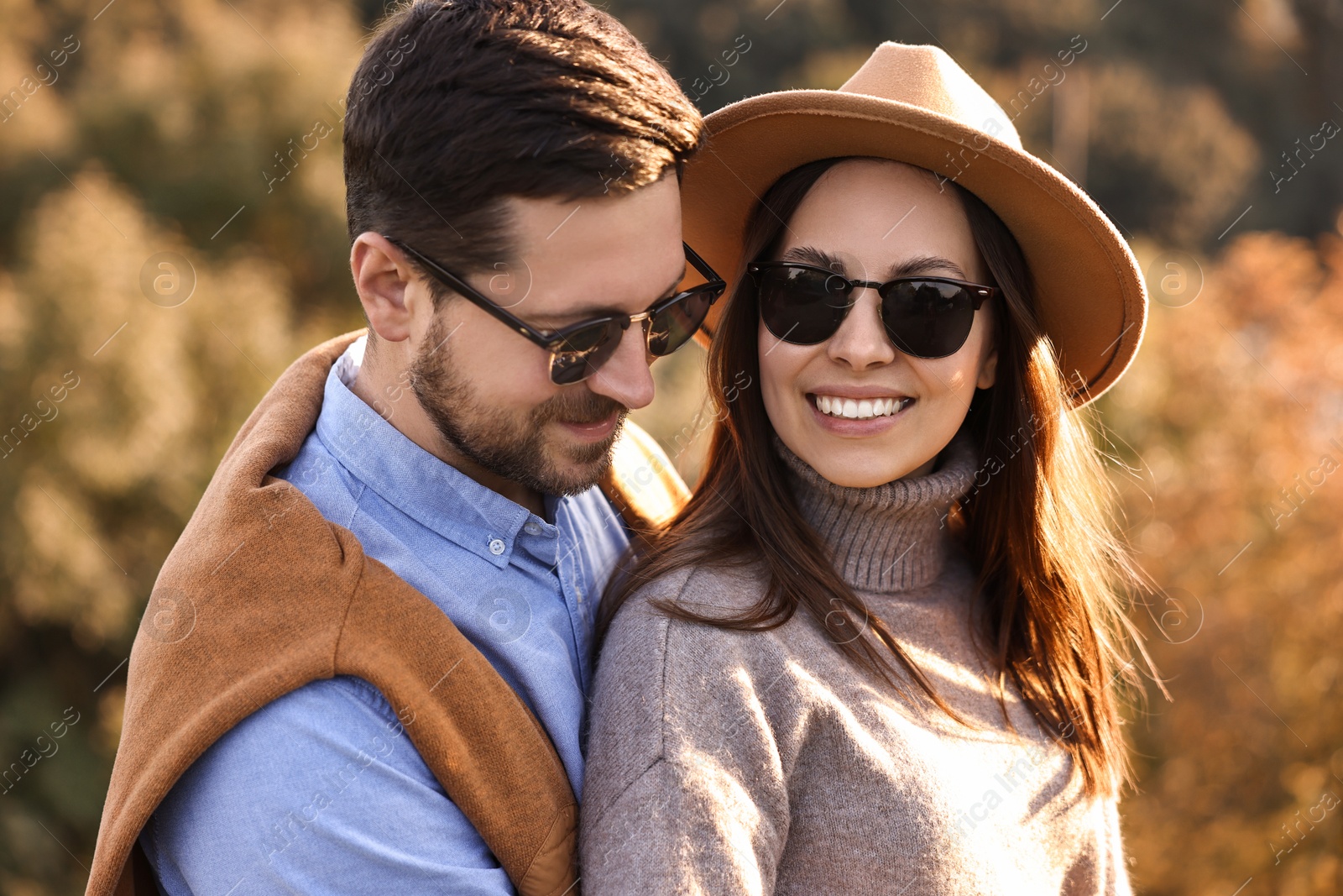 Photo of Beautiful happy couple in sunglasses outdoors on autumn day