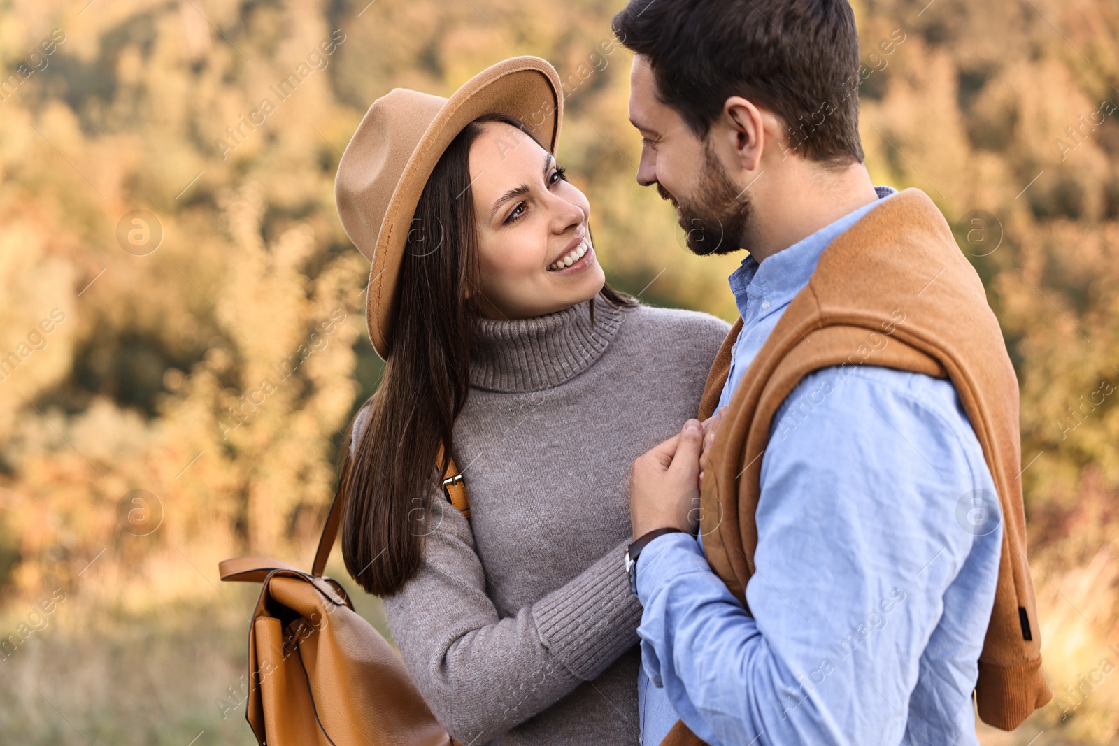 Photo of Beautiful couple spending time together outdoors on autumn day