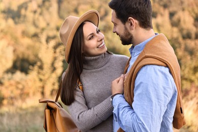 Beautiful couple spending time together outdoors on autumn day