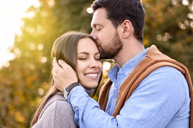 Beautiful couple spending time together outdoors on autumn day