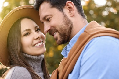 Beautiful couple spending time together outdoors on autumn day