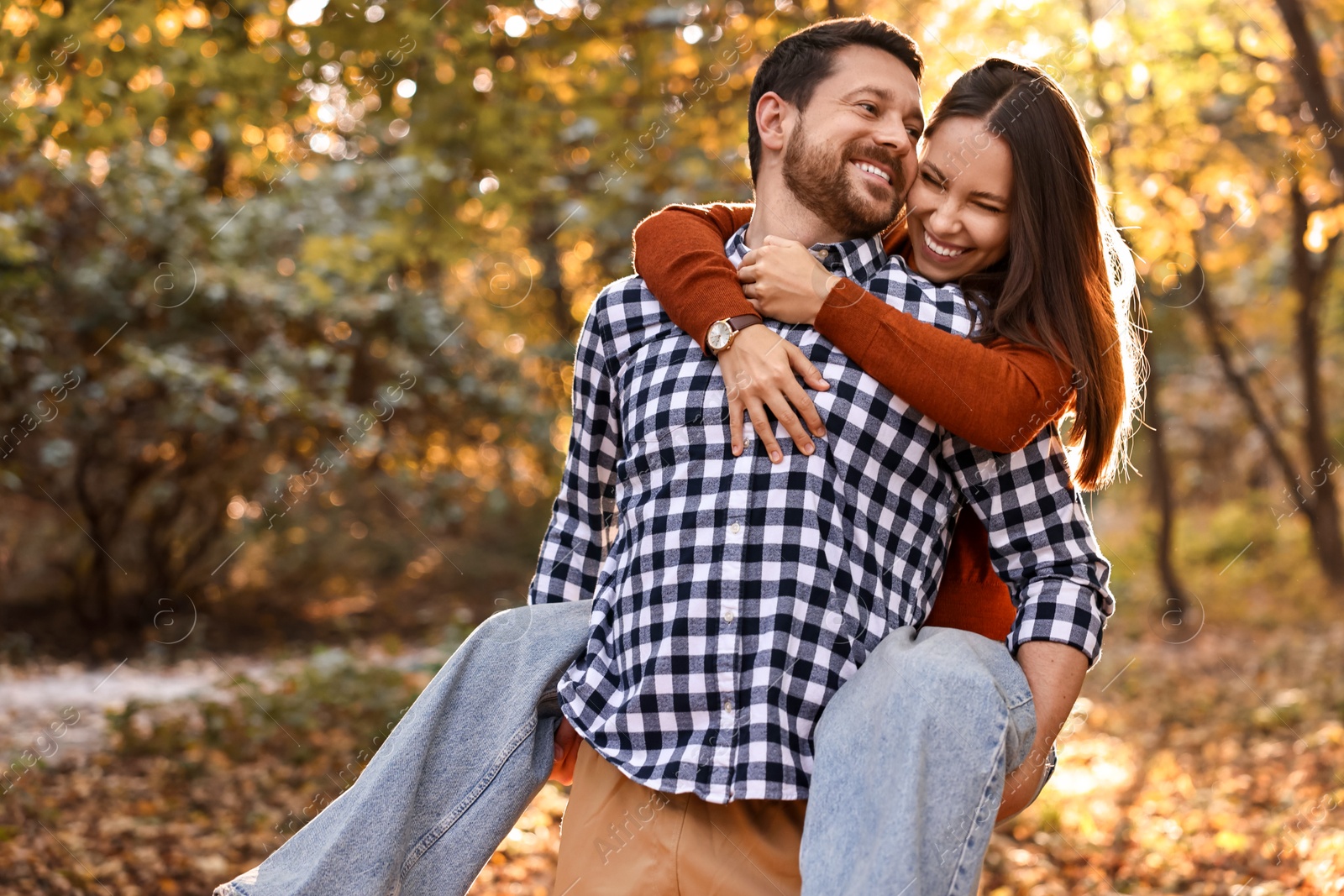 Photo of Beautiful couple having fun together in park on autumn day