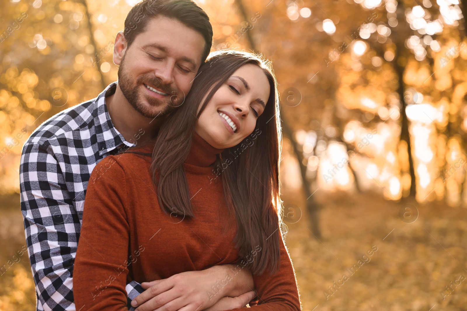 Photo of Beautiful couple spending time in park on autumn day