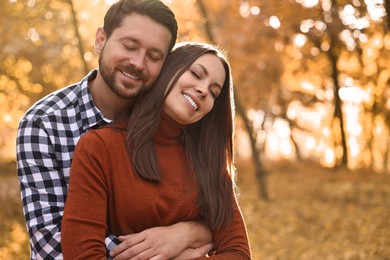 Photo of Beautiful couple spending time in park on autumn day