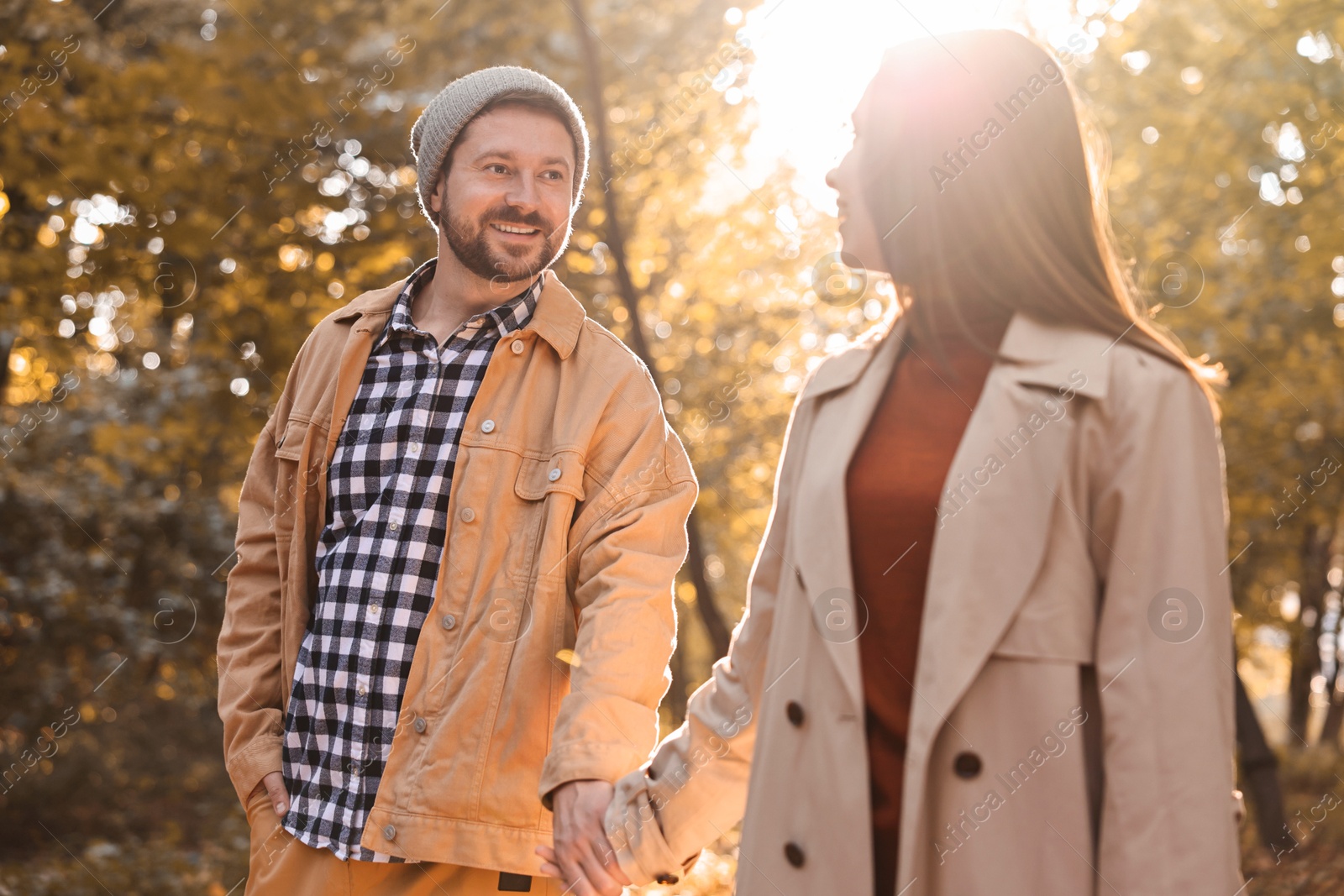 Photo of Beautiful couple walking together in autumn park