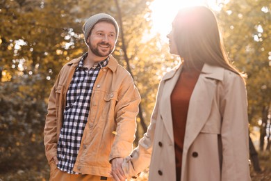 Beautiful couple walking together in autumn park