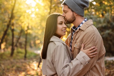 Photo of Beautiful couple spending time in park on autumn day