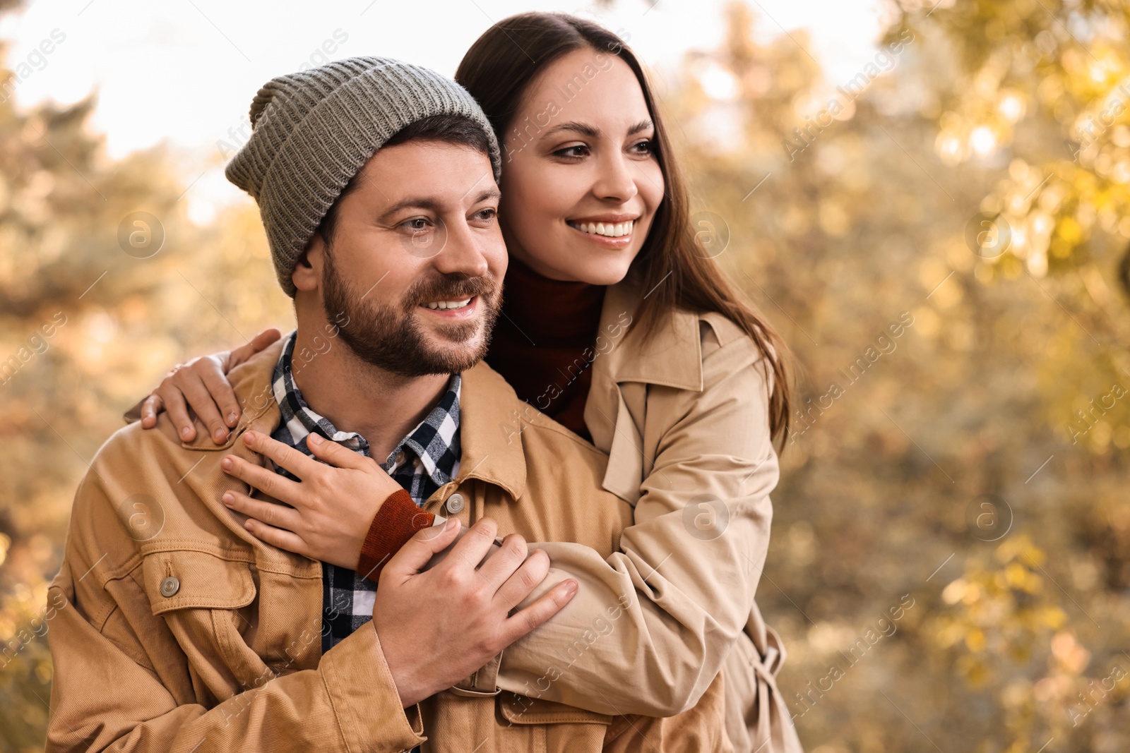 Photo of Beautiful happy couple hugging outdoors on autumn day