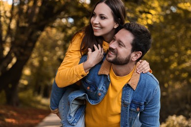 Beautiful couple spending time together in park on autumn day