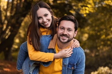 Portrait of beautiful couple in park on autumn day