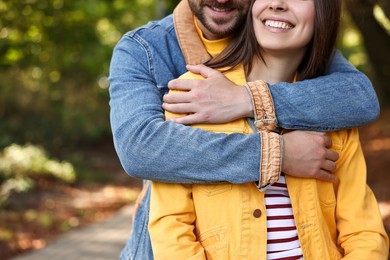 Couple hugging in autumn park, closeup view