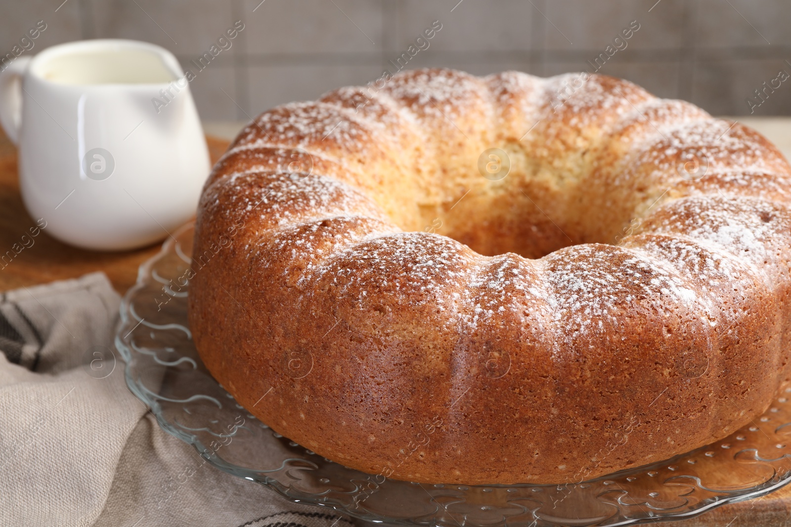 Photo of Freshly baked sponge cake and milk on table, closeup