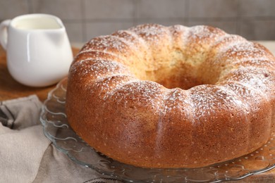 Photo of Freshly baked sponge cake and milk on table, closeup