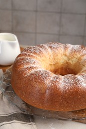 Freshly baked sponge cake and milk on table, closeup