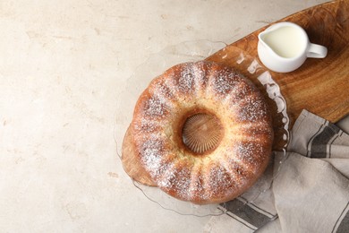 Freshly baked sponge cake and milk on light grey table, top view. Space for text