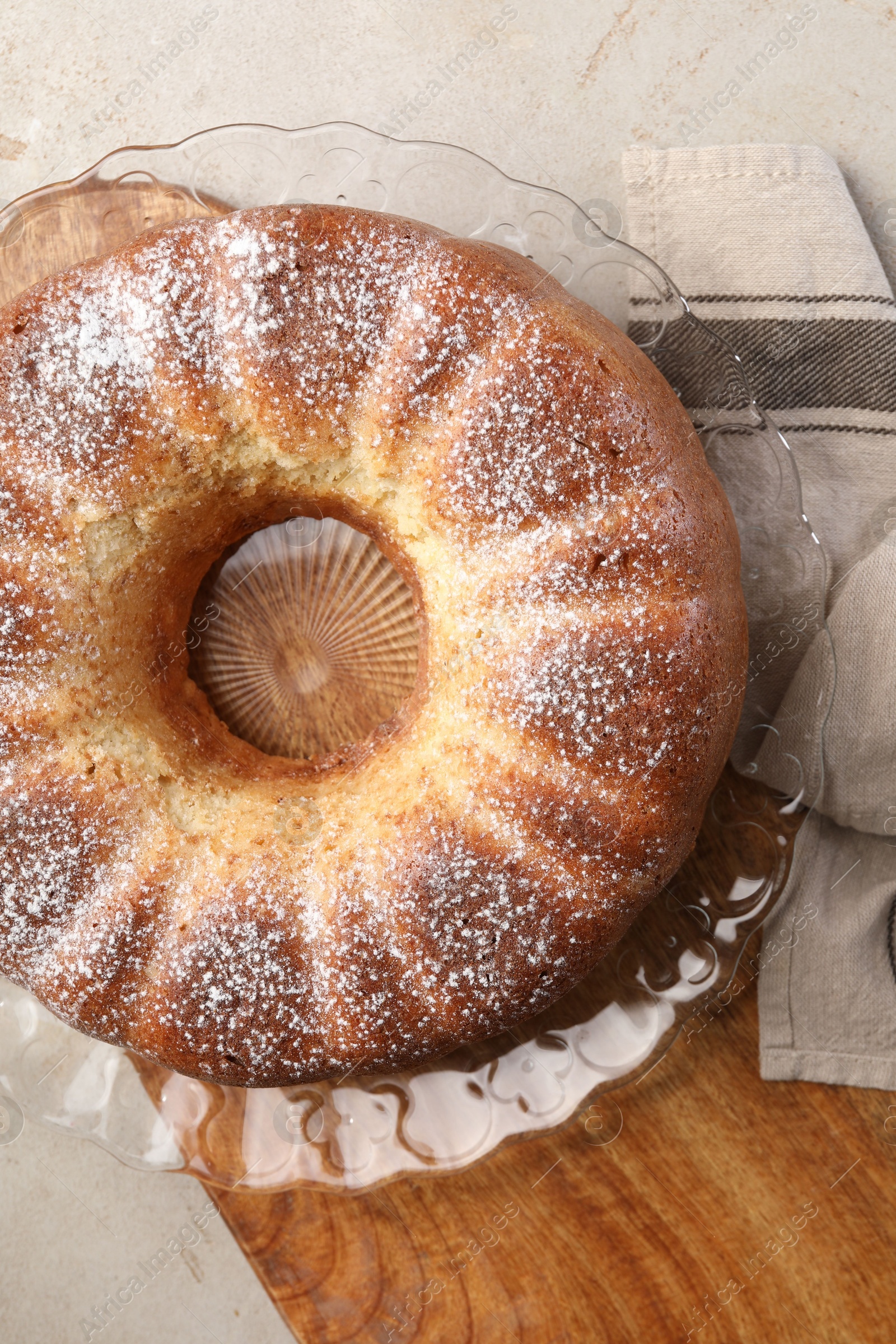 Photo of Freshly baked sponge cake on light grey table, top view