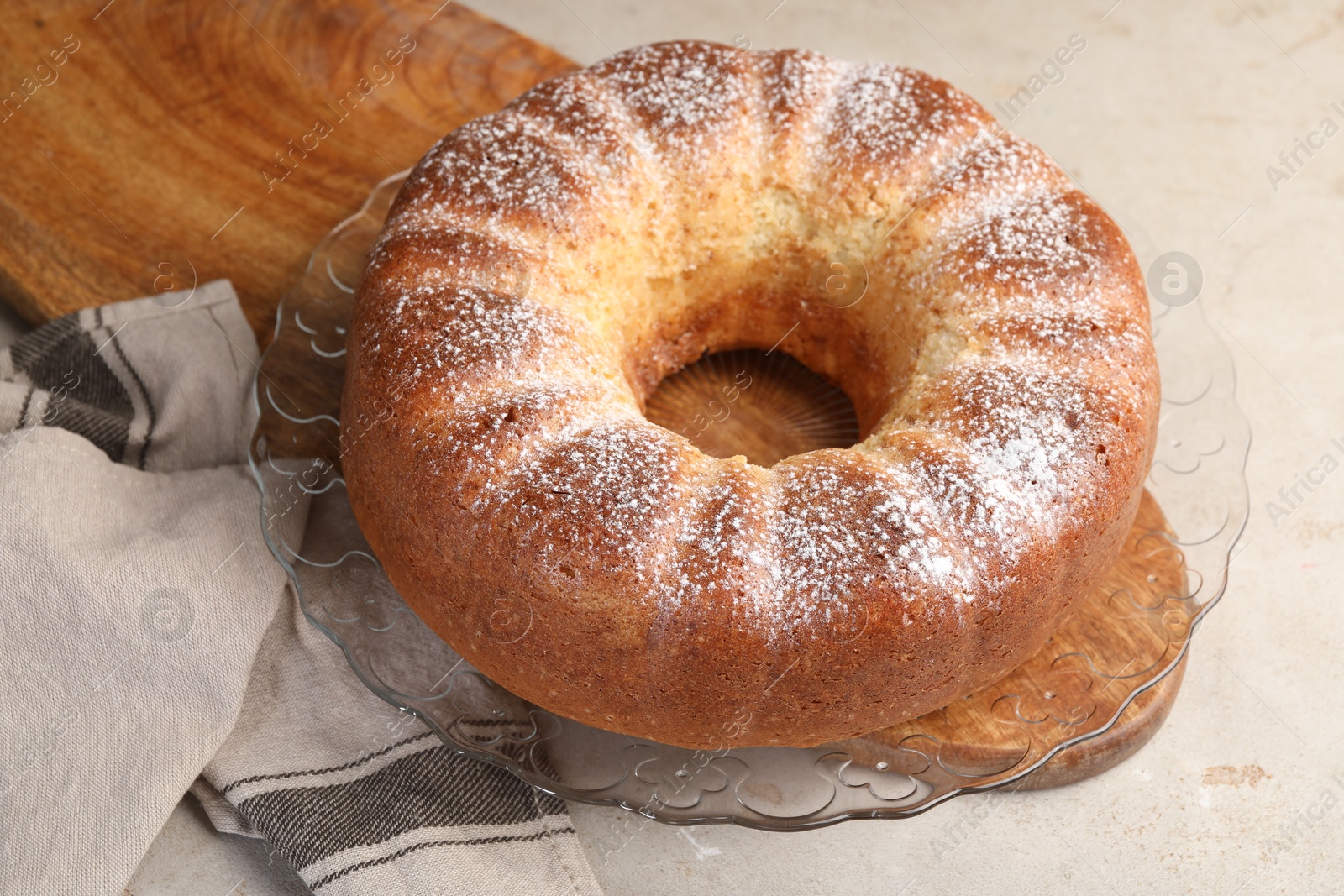 Photo of Freshly baked sponge cake on light grey table, closeup