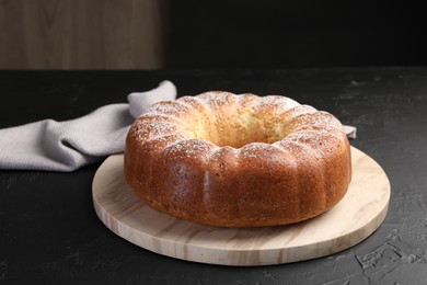 Photo of Freshly baked sponge cake on black table