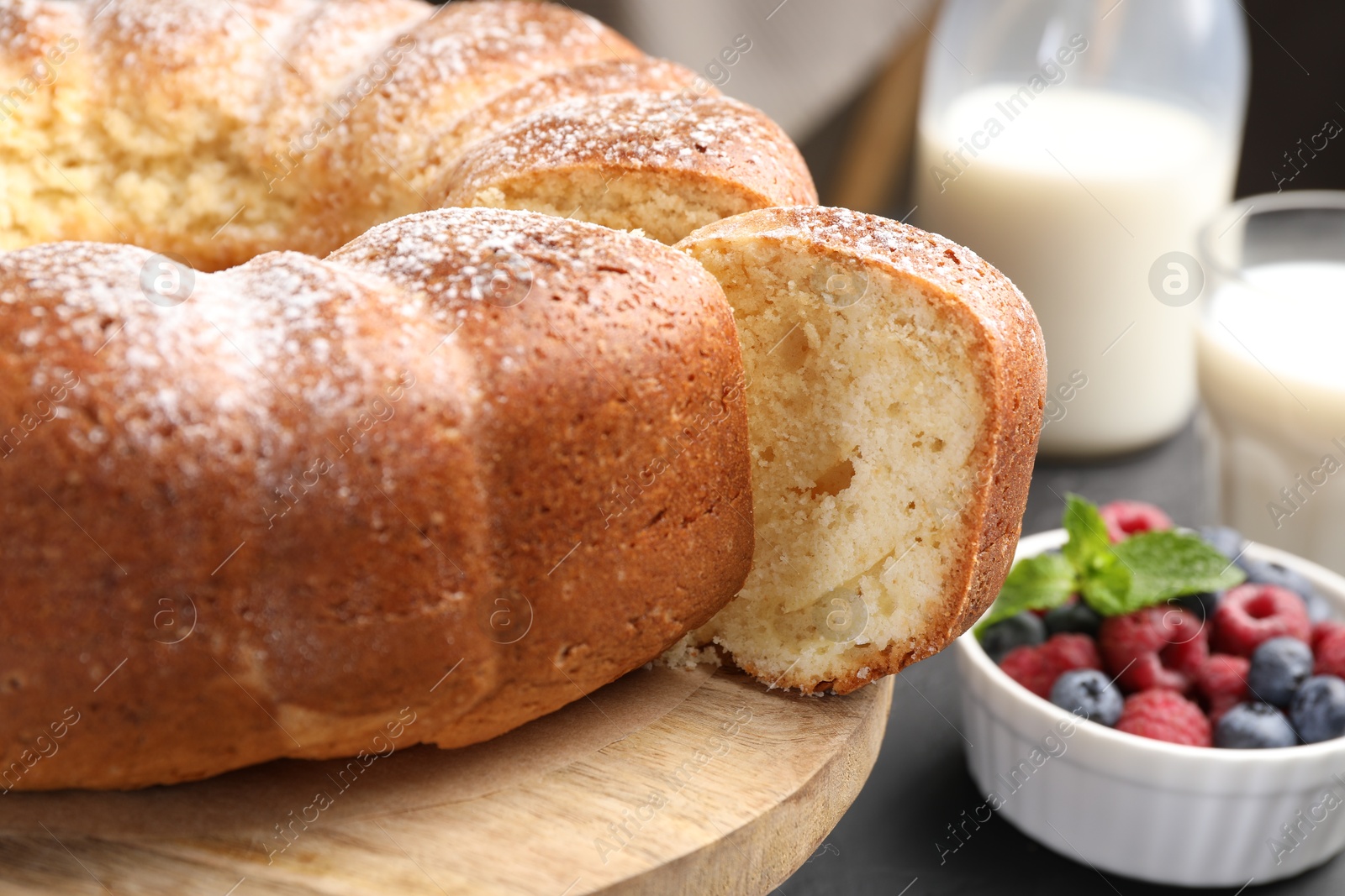 Photo of Freshly baked sponge cake, berries and milk on table, closeup