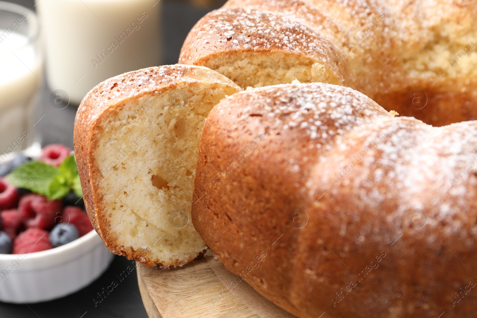 Photo of Freshly baked sponge cake, berries and milk on table, closeup