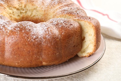 Photo of Freshly baked sponge cake on white textured table, closeup