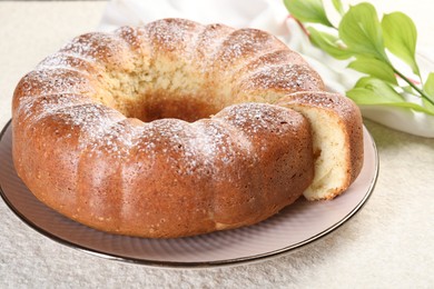 Photo of Freshly baked sponge cake on white textured table, closeup