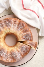 Photo of Freshly baked sponge cake on white textured table, top view