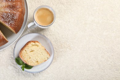 Piece of freshly baked sponge cake, mint and coffee on white textured table, top view. Space for text