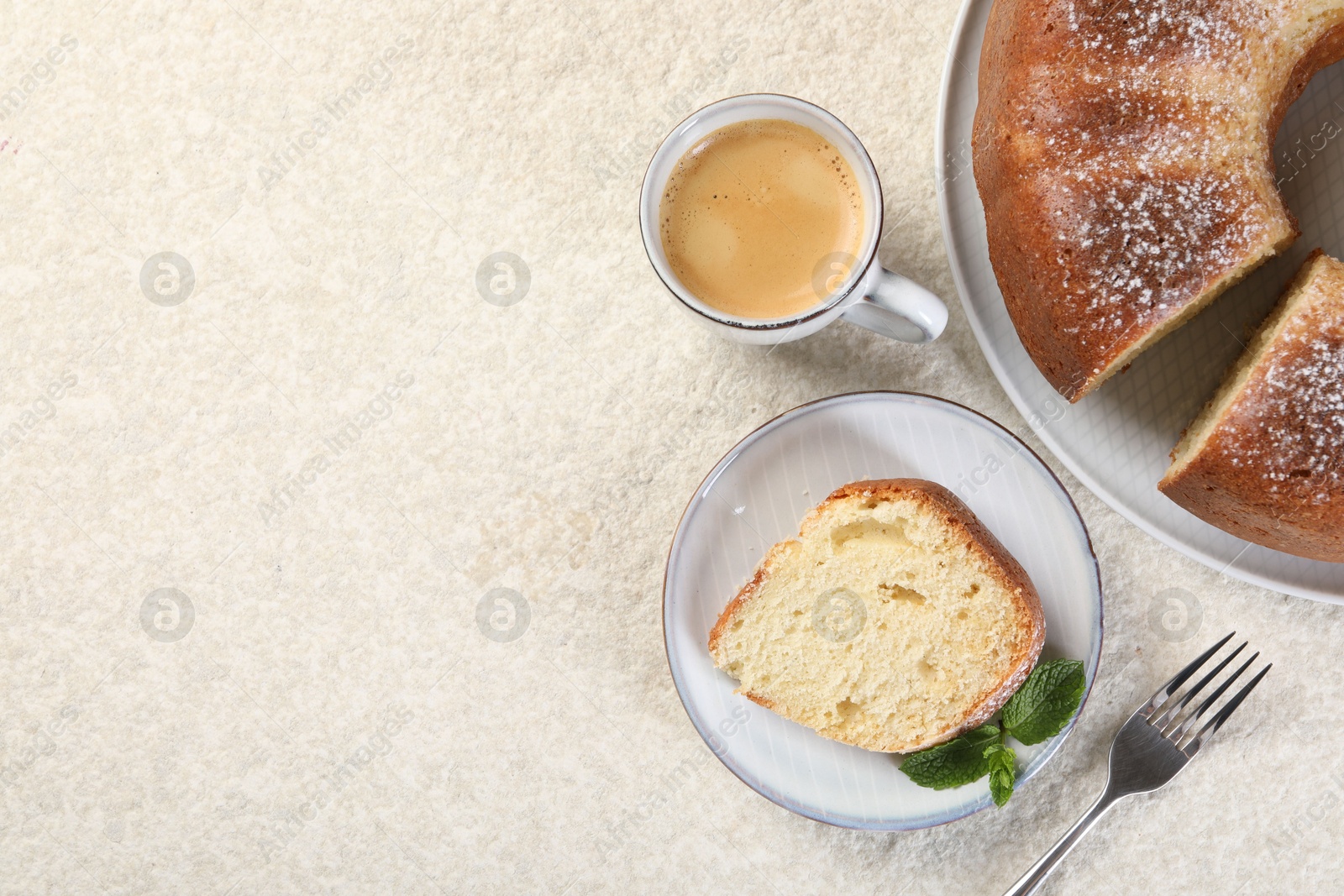 Photo of Piece of freshly baked sponge cake, mint and coffee on white textured table, top view. Space for text