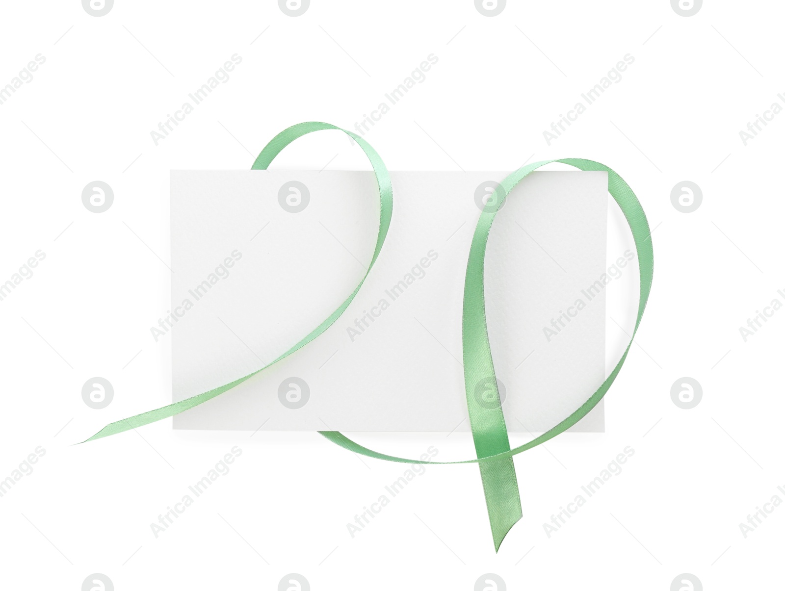 Photo of Blank card and ribbon isolated on white, top view