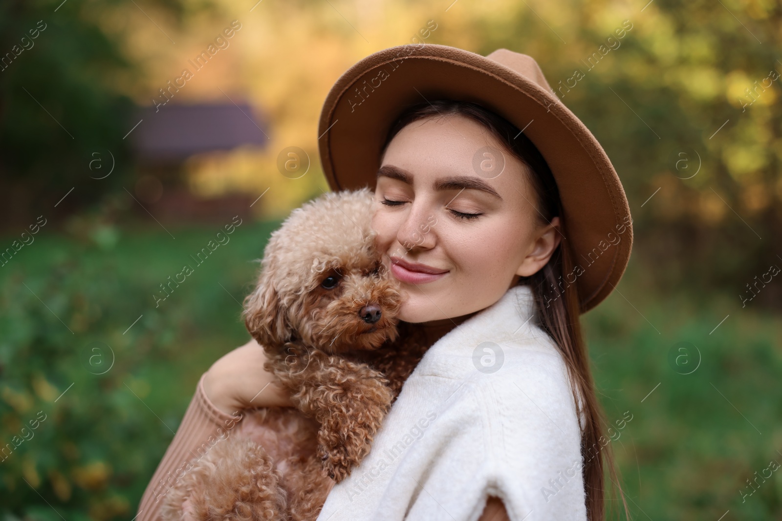 Photo of Portrait of woman with cute dog outdoors