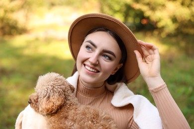 Portrait of smiling woman with cute dog outdoors