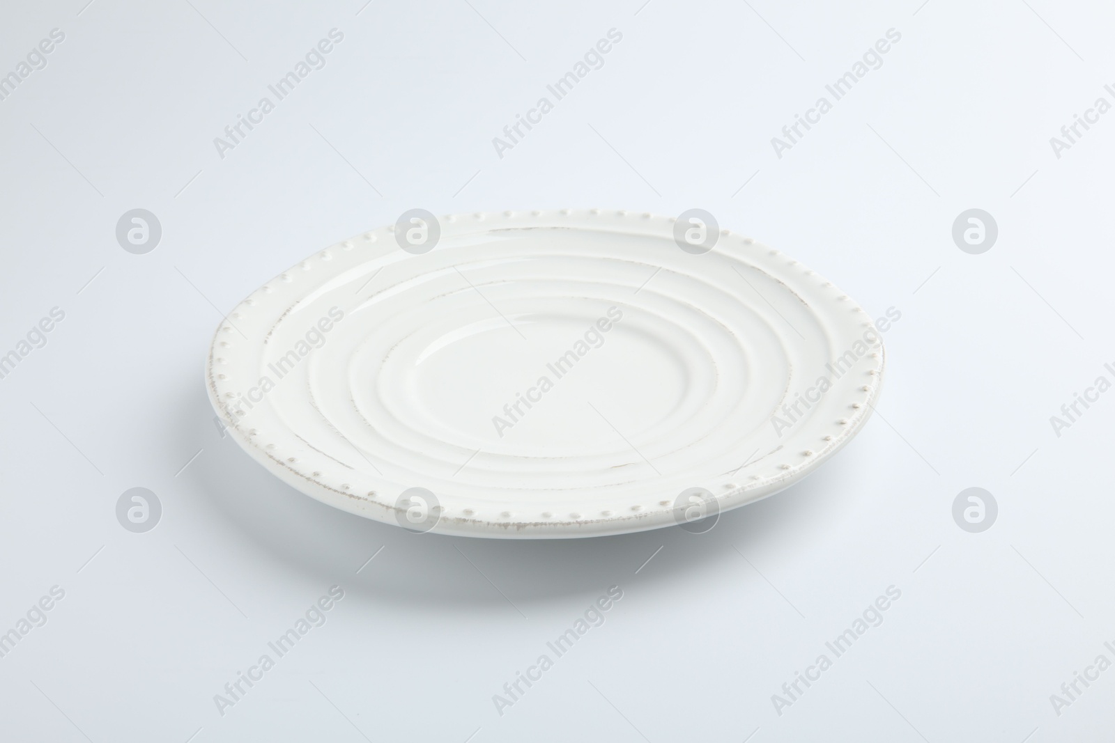 Photo of One empty ceramic plate isolated on white