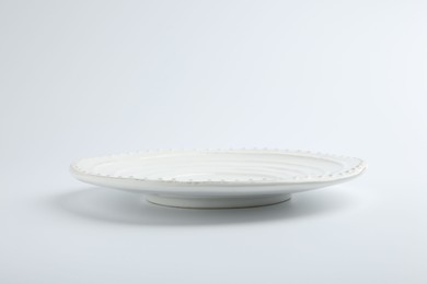 Photo of One empty ceramic plate isolated on white