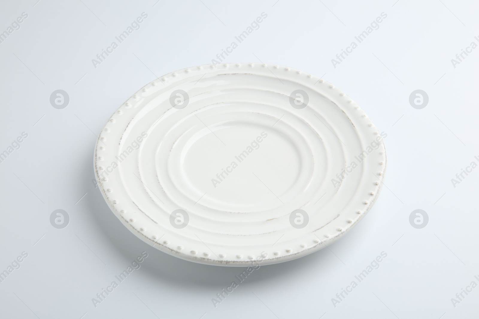 Photo of One empty ceramic plate isolated on white